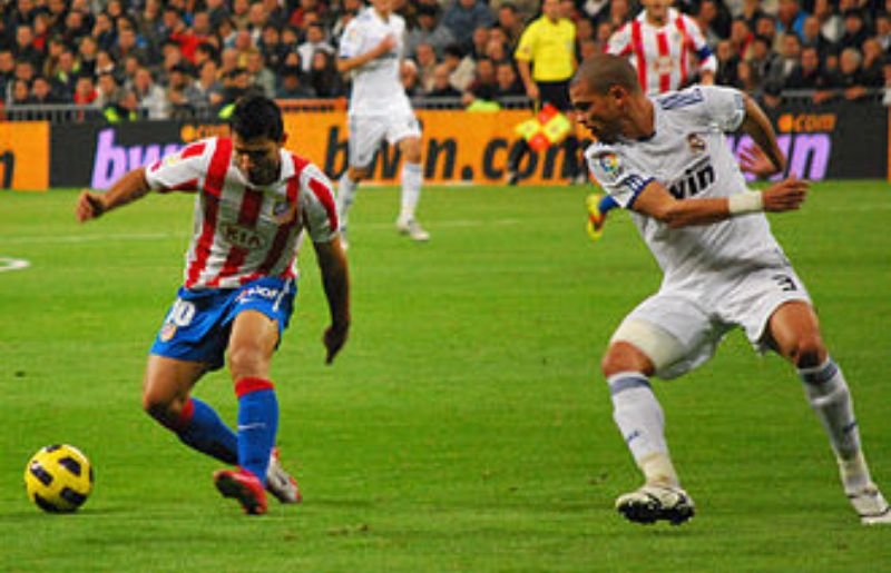 Agüero (left; pictured with Pepe) with Atlético Madrid during the 2010–11 season
